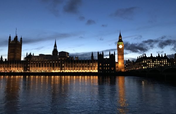 An evening photo of the House of Commons, from across the Thames