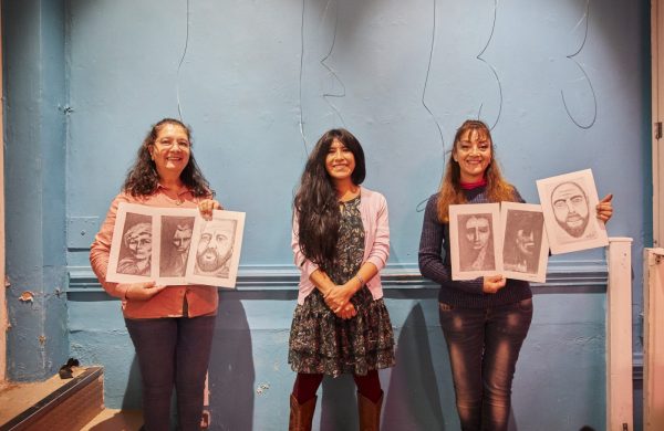 Volunteers with art at Migrant Support