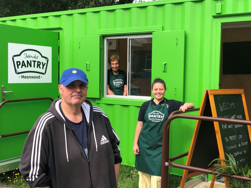 InterACT Pantry in Leeds: a green shipping container, with three people outside