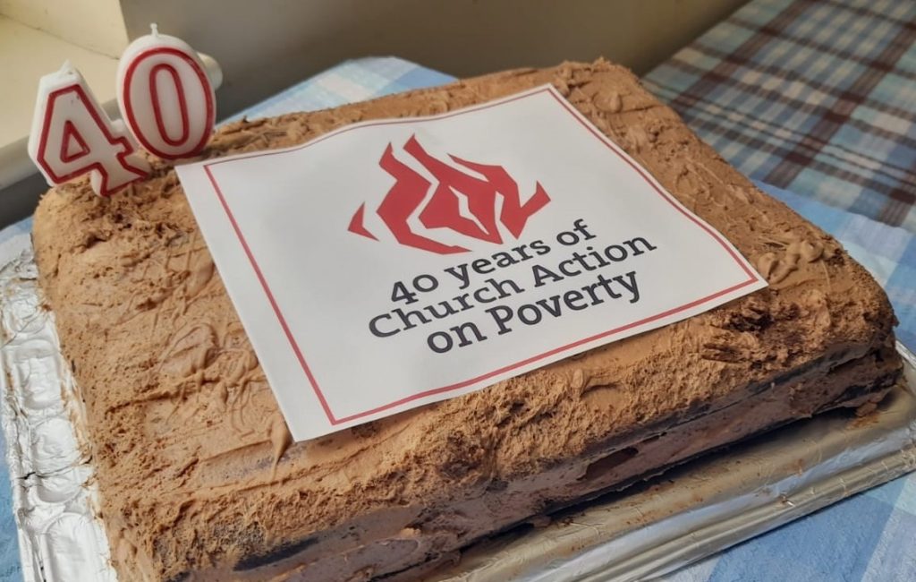 A large rectangular cake, with "40 years of Church Action on Poverty" on the top.