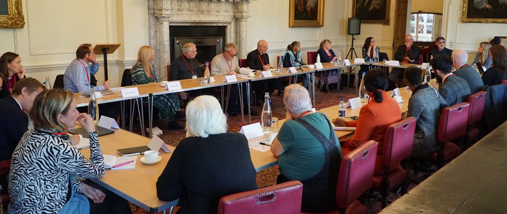 A shot of people around a large table, including the Archbishop of York