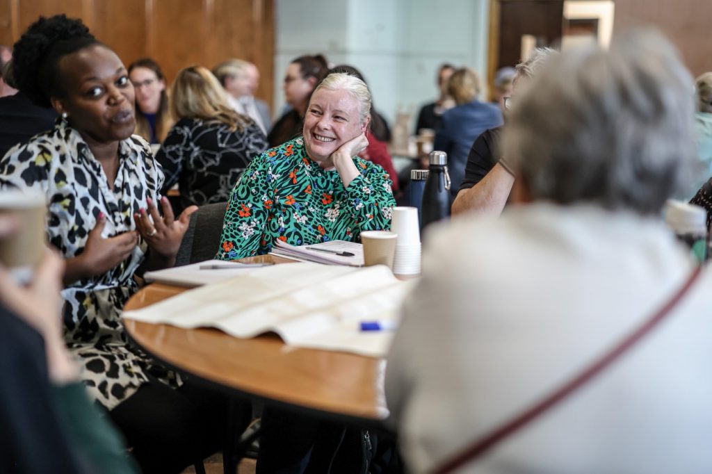 Attendees at the Greater Manchester Big Poverty Conversation discuss issues around their table