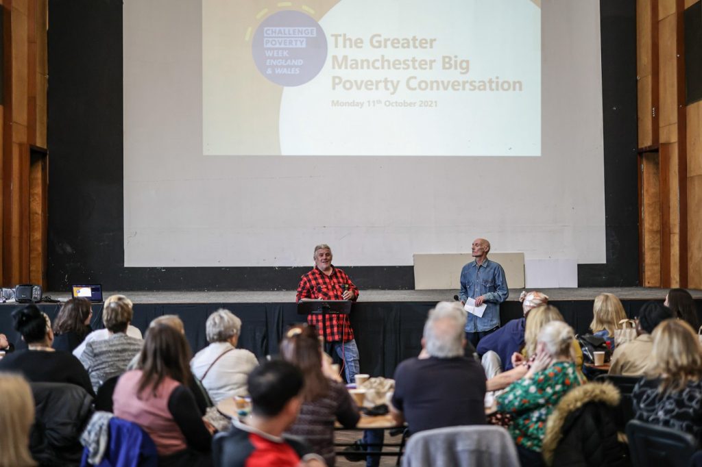 Attendees at the Greater Manchester Big Poverty Conversation listen to one of the speakers on stage.