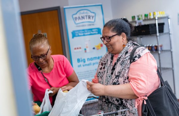 Two Pantry members with their shopping at Peabody Pantry in Chingford