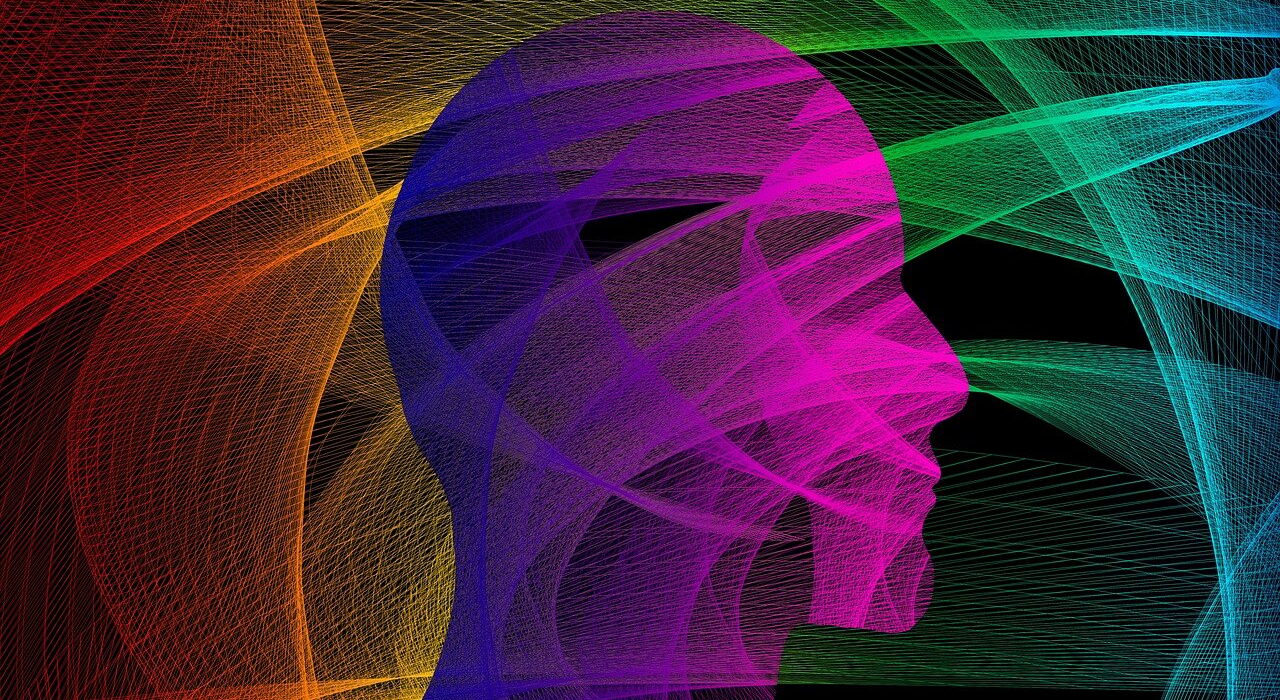 A silhouette head, with multiple coloured lines criss-crossing