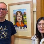 Rebecca stands beside her portrait, with artist Stephen Martin