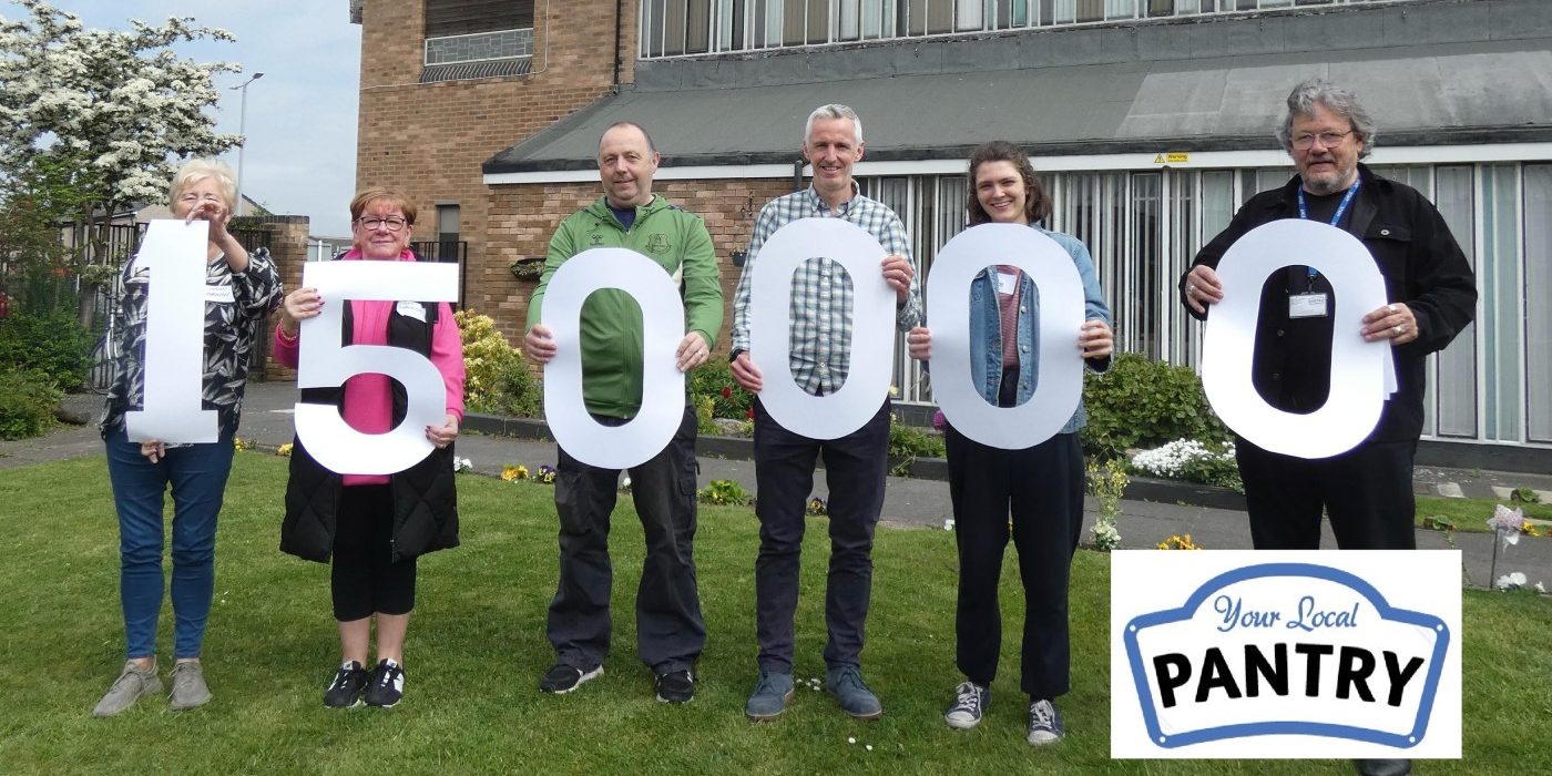 6 people holding cut-out numbers, reading 150,000