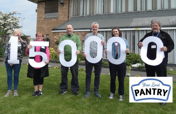 6 people holding cut-out numbers, reading 150,000