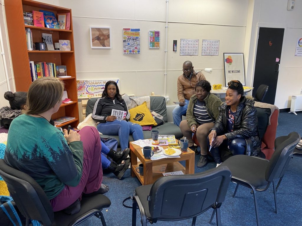 People sitting chatting around a coffee table