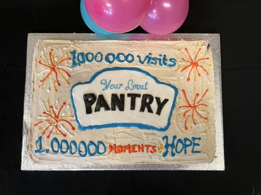 A large rectangular cake with the Your Local Pantry logo and "1,000,000 visits" written on top.